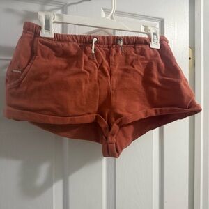 Vuori Women's Athletic Shorts in Rust